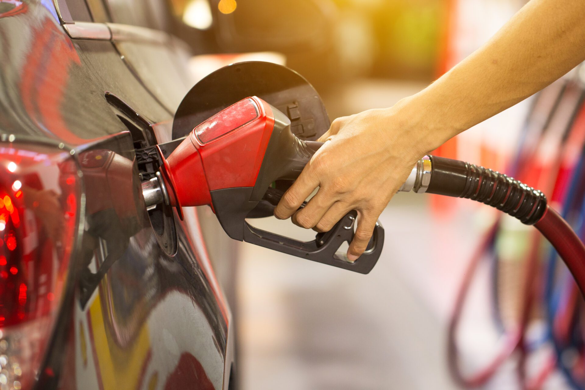 Pumping gas at gas pump. Closeup of man pumping gasoline fuel in car at gas station. Fuel Pumps Winkler, MB